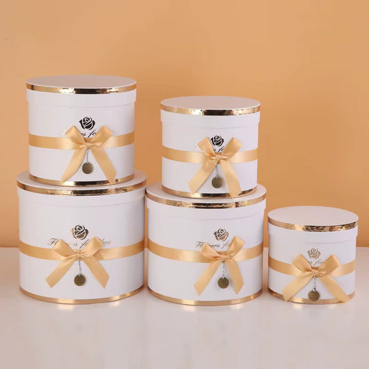 White Floral arrangement gift boxes in luxury design with ribbon decoration.
