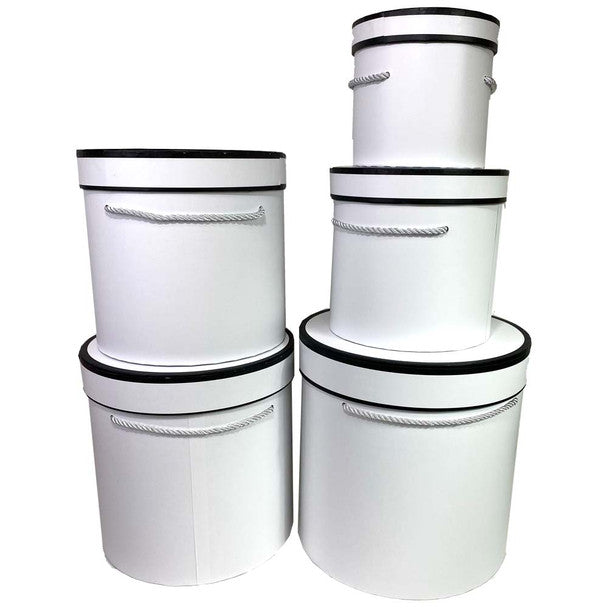 Set of white round gift boxes with black trim and rope handles, stacked in display.