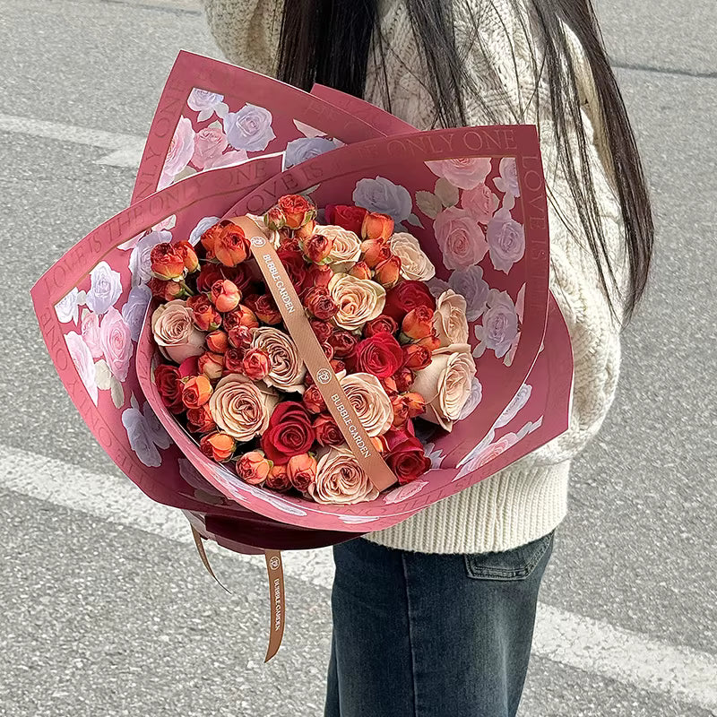 Wrapping paper roll with roses and “LOVE IS THE ONLY ONE” text
