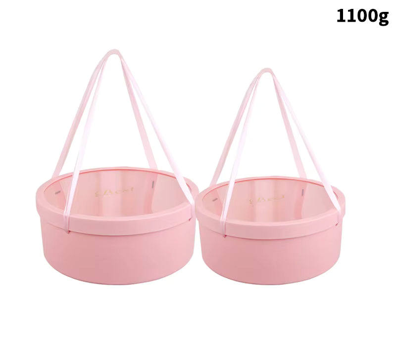 Pink round packaging box with satin ribbons and printed lid