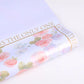 Close-up of pastel purple floral waterproof gift wrap with rose print