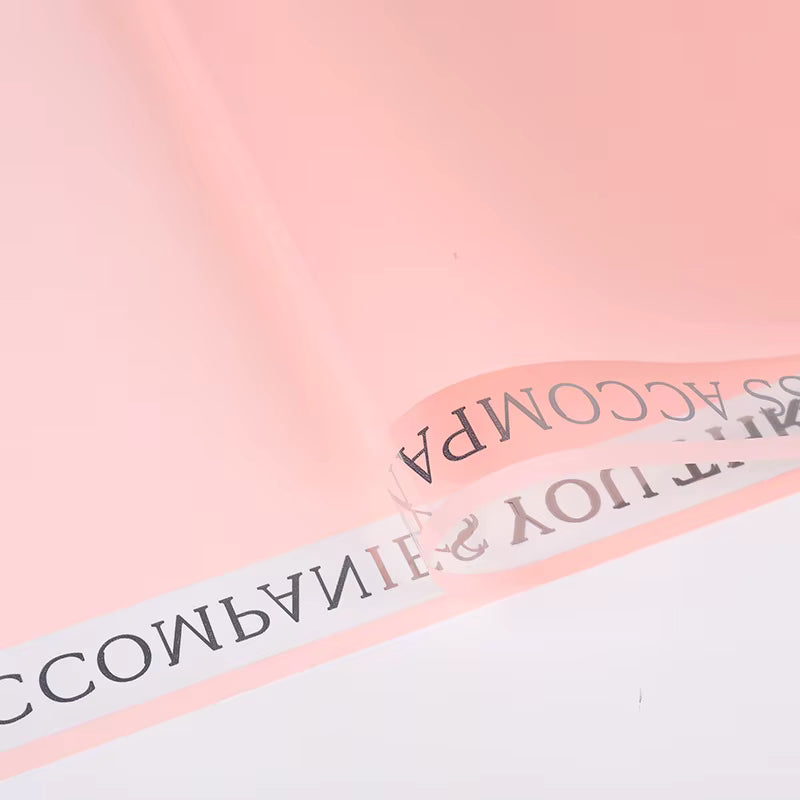 Plastic flower packaging with fall-in-color ribbon design