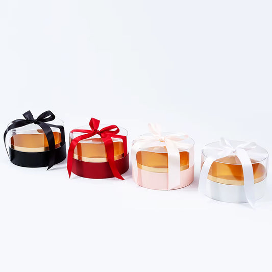 Transparent acrylic round box with red ribbon for elegant packaging