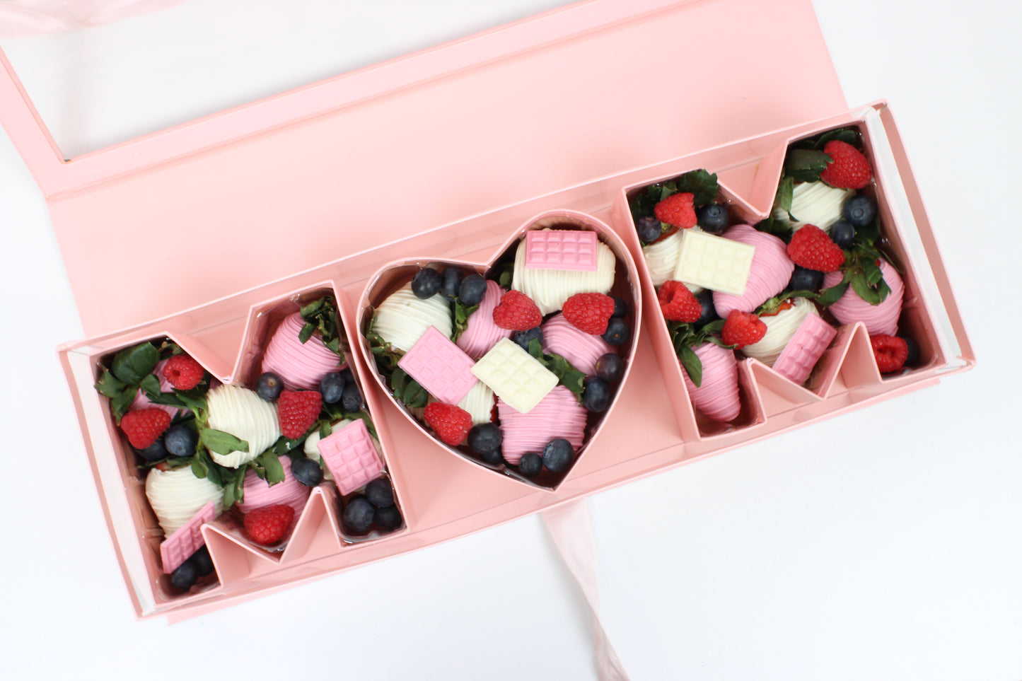 Close up of Pink Mother's Day Flower Gift Box  showcasing chocolate strawberries for Mother's Day.