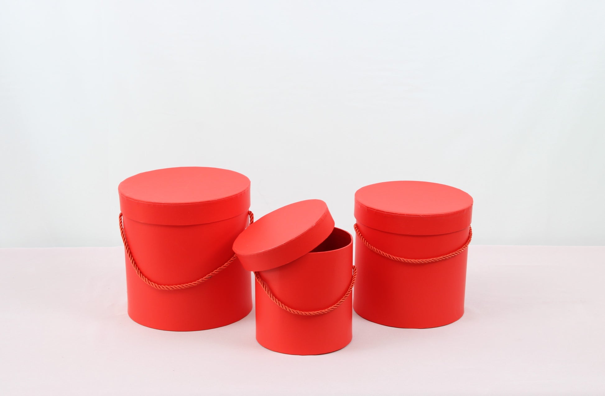 Close-up of Red Round Hat Box for flower bouquets and chocolate strawberries.