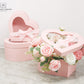 Pink Heart Shaped Box with Ribbon and Clear Lid displaying a flower arrangement
