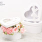 White Heart Shaped Boxes displaying beautiful flower arrangement