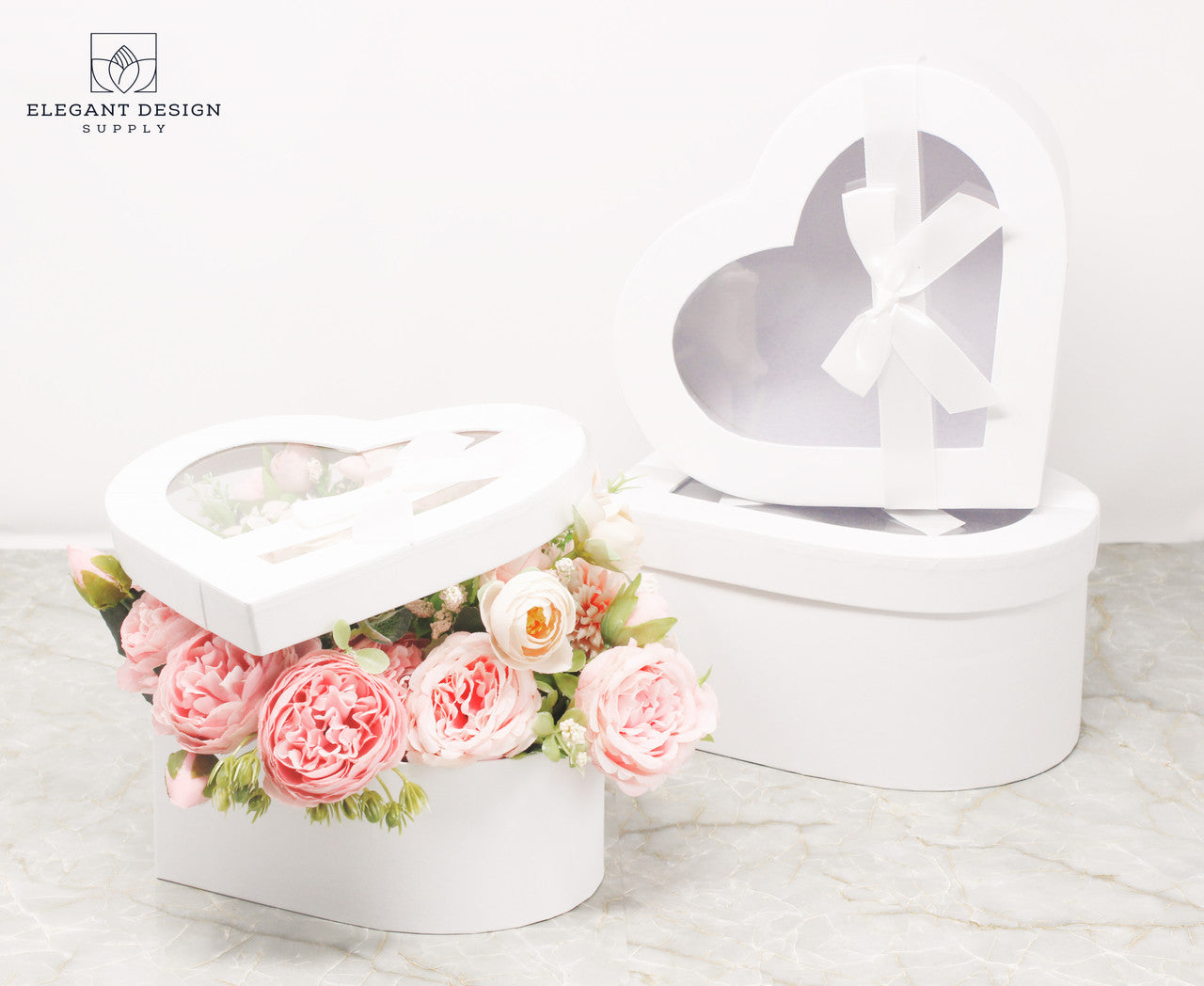 White Heart Shaped Boxes displaying beautiful flower arrangement