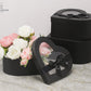 Black Heart Shaped Boxes displaying a flower arrangement