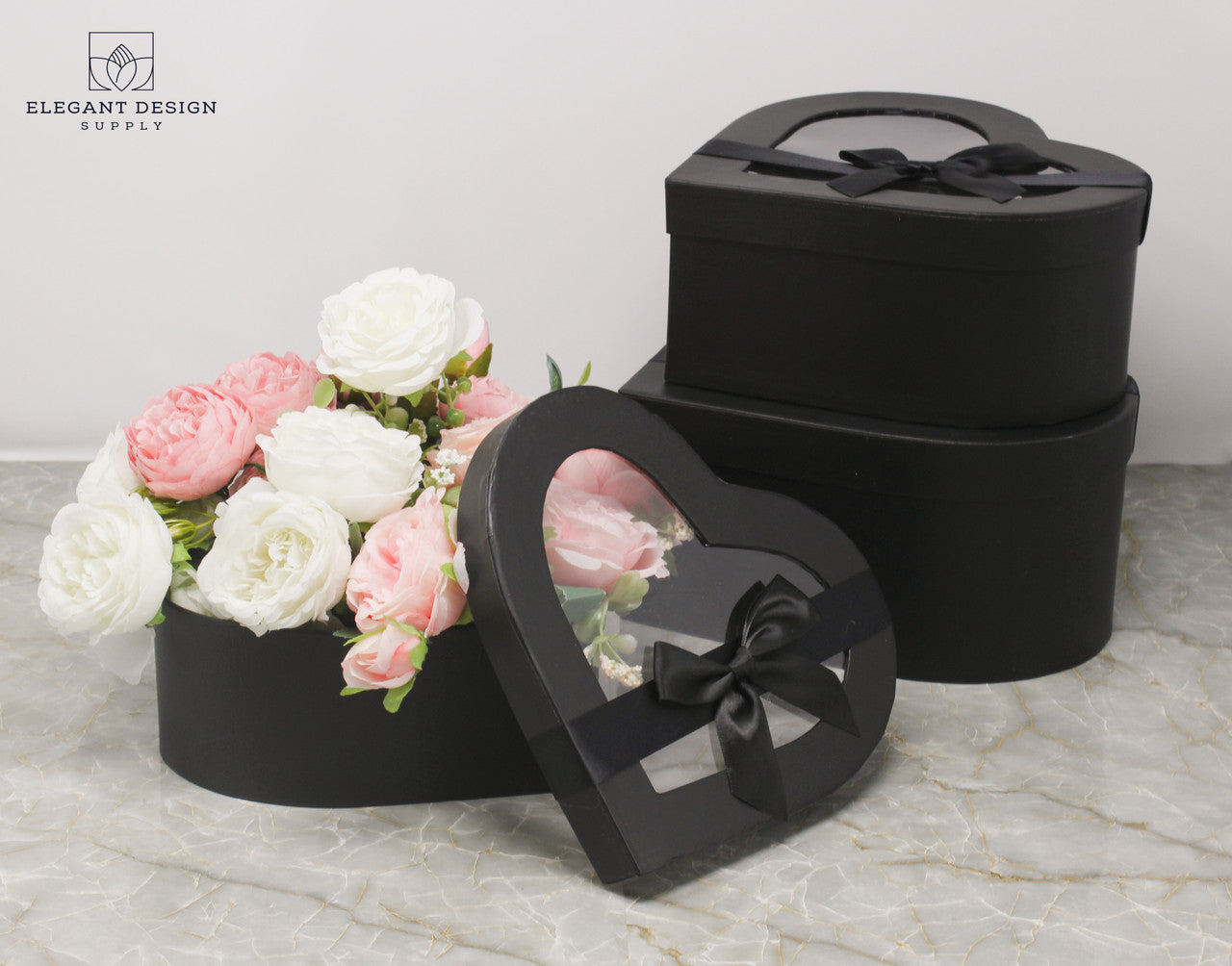 Black Heart Shaped Boxes displaying a flower arrangement