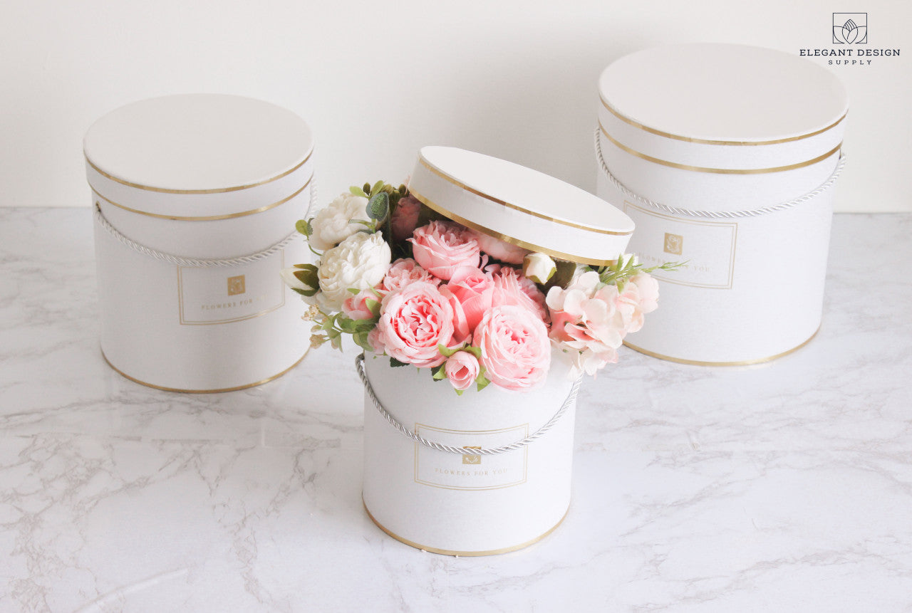 White Round Hat Flower Boxes showcasing a beautiful flower arrangement!